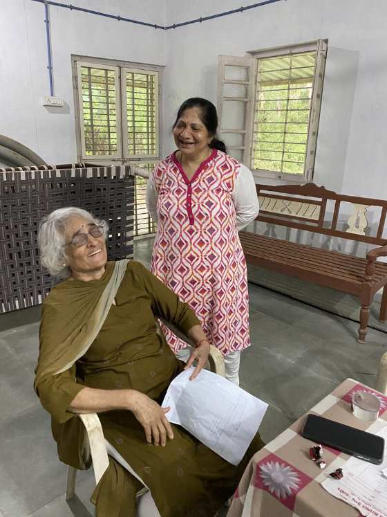 A doctor consulting with an elderly patron during a wellness camp session