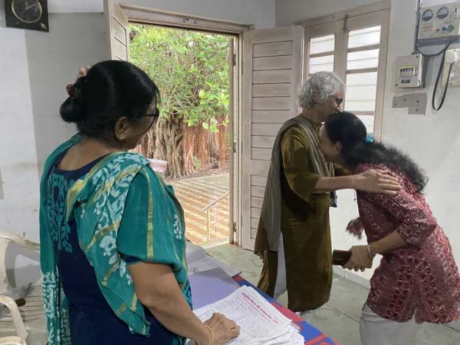 Volunteers keeping patient records at the registration table of the camp